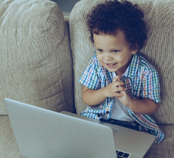 Small child looking at laptop